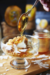 Wildflower honey dripping onto granola and yogurt