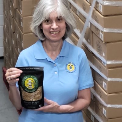 Deborah showing granola boxes