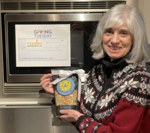 Deborah O'Kelly holding Original granola and displaying Giving Tuesday announcement.