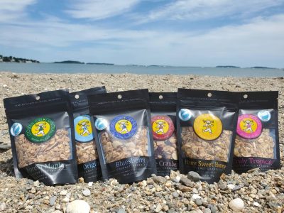 Granola snack packs on a beach during summer.