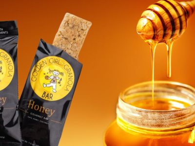 Honey granola bar with honey jar and dipper.